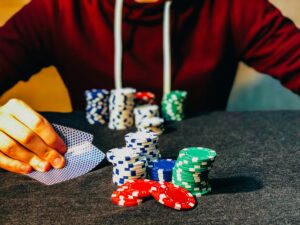Person playing with poker chips on the table