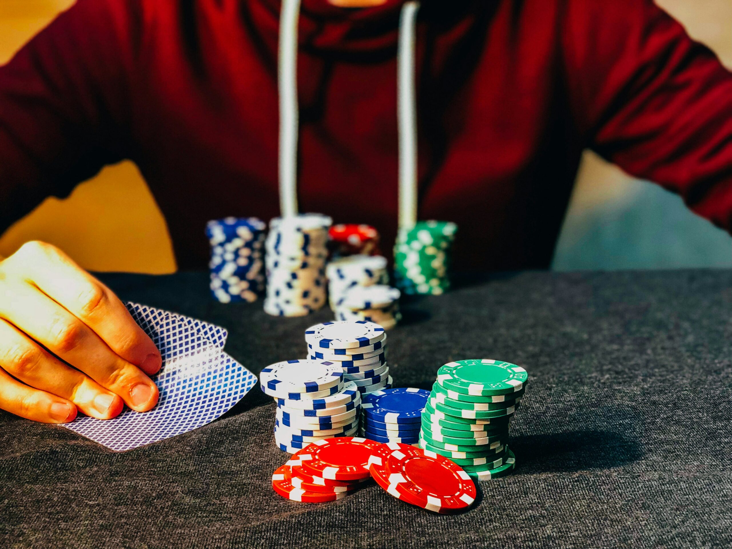 Person playing with poker chips on the table